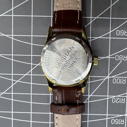 Brown 26mm Liaocheng TAISHAN lady watch featuring manual mechanical movement, 19 jewels, and gold nail accents.