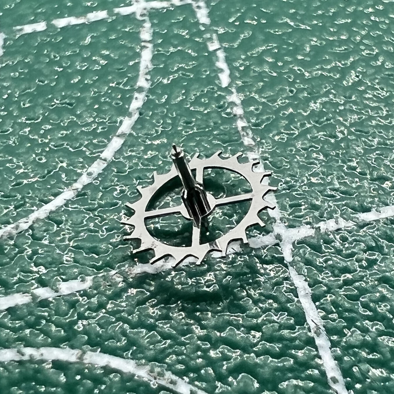Escape wheel for Dandong 7750 watch movement, durable precision part for repair and replacement.