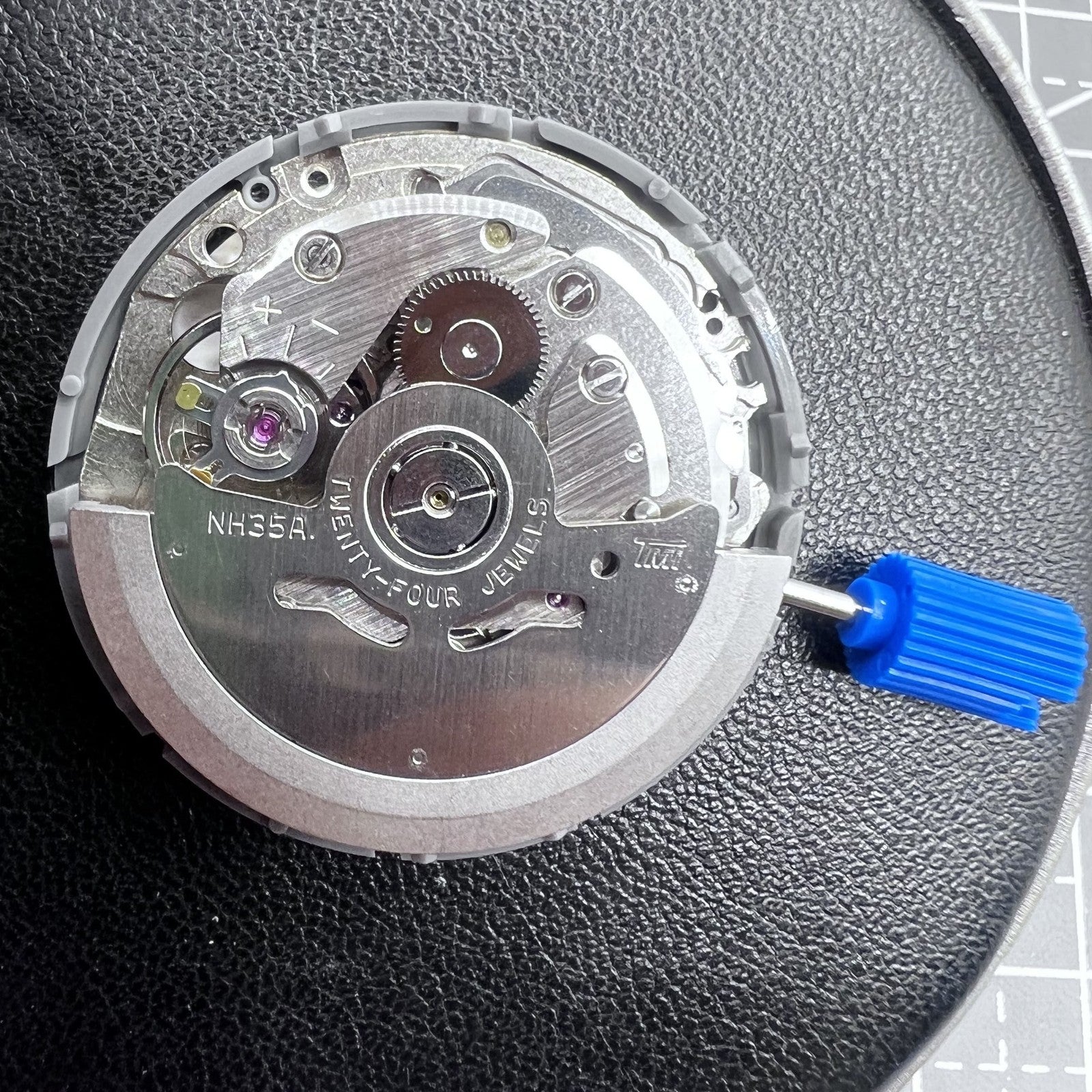 Seiko NH35 automatic watch movement with high precision and vibrant orange dial, ideal for watch repairs.