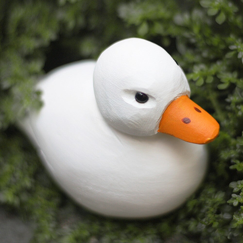 Handmade white wooden Cole Duck figurine sculpture, decorative watch accessory enhancing style and elegance.
