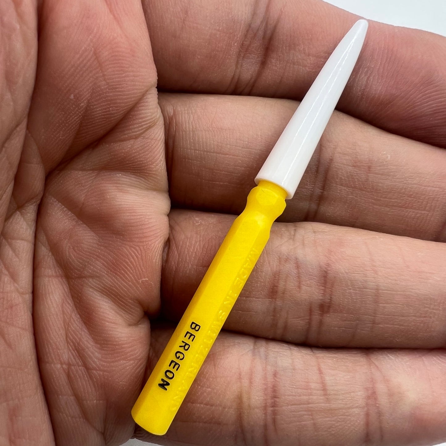 Bergeon 30102-D yellow watch dip oiler for precise Swiss watch repair and maintenance tasks.