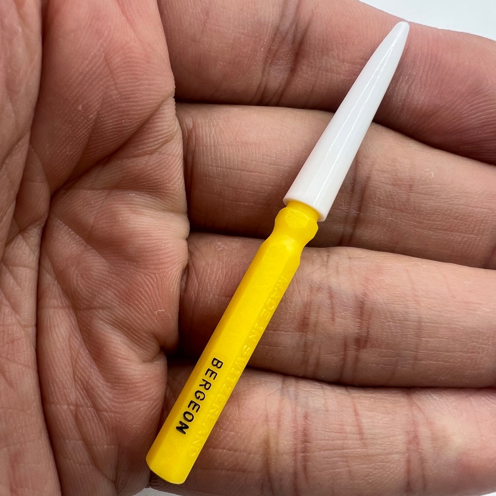 Bergeon 30102-D yellow watch dip oiler for precise Swiss watch repair and maintenance tasks.