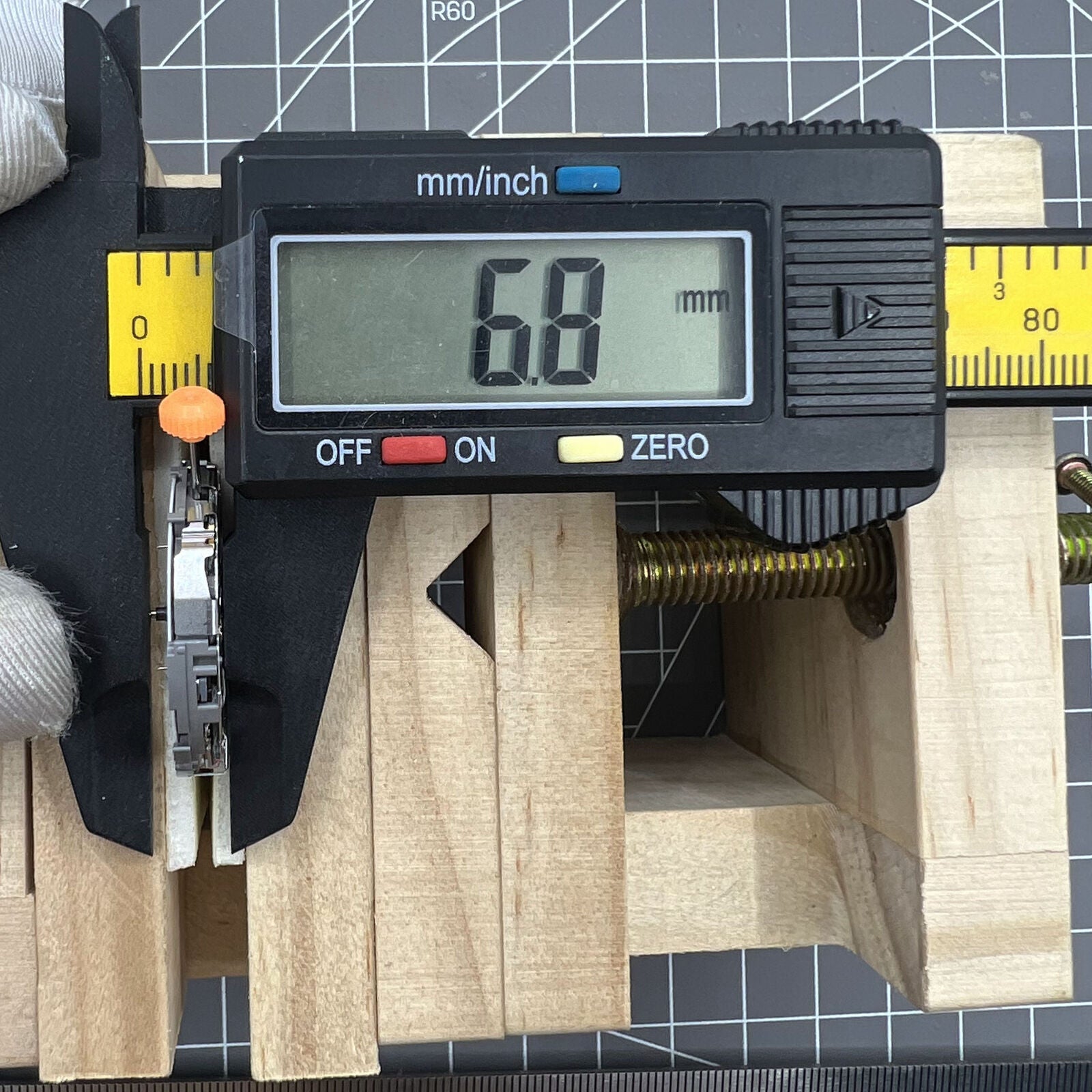 Miyota JS26 quartz watch movement showing small seconds at 3, 6, 9 and date window at 3, Japan made.