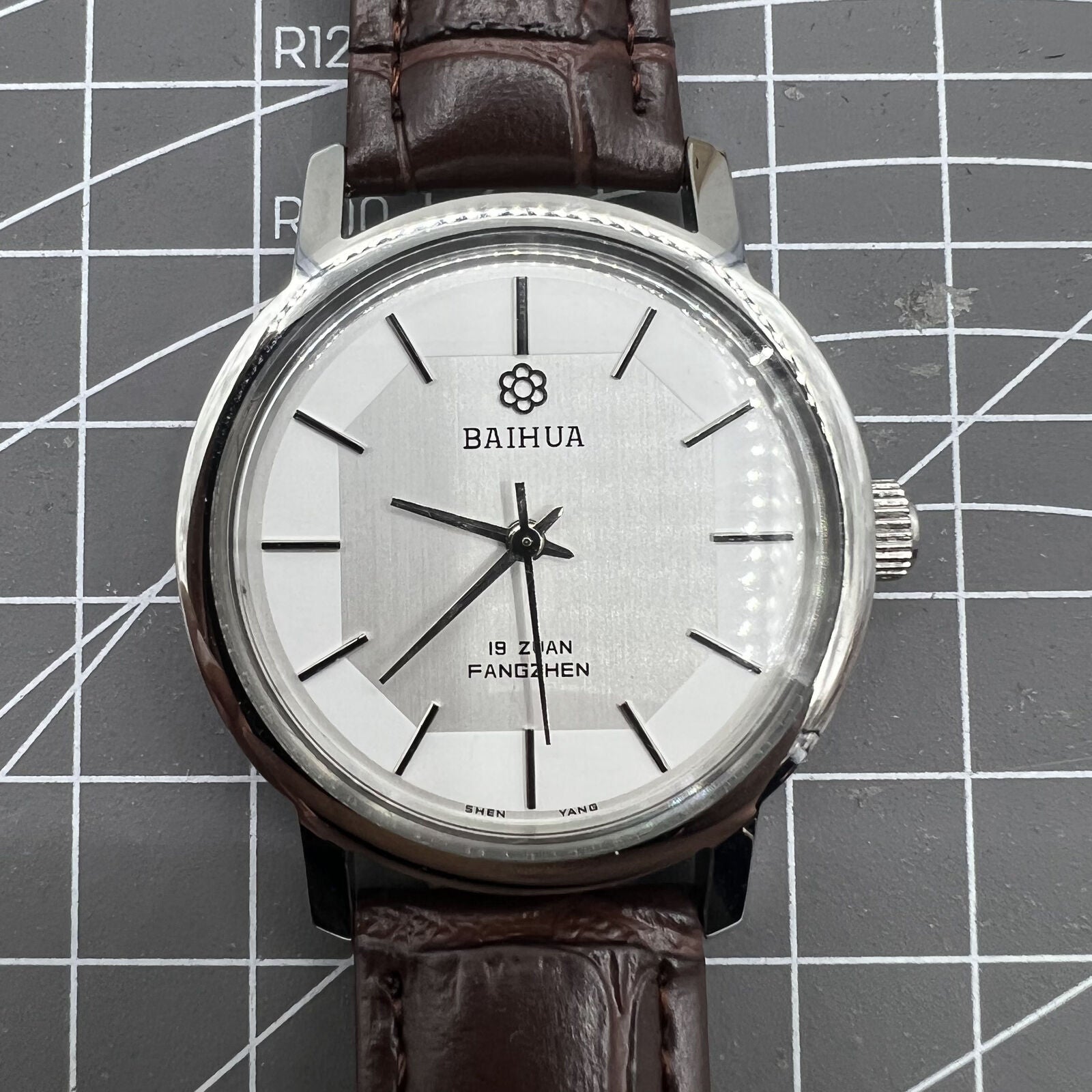 China Baihua 37mm manual mechanical watch with silver dial and 19-jewel shock-resistant movement.