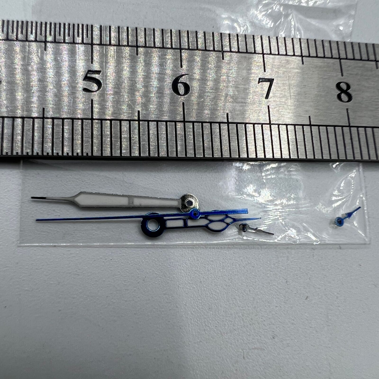 Blue-trimmed green lume watch hands for Miyota OS10, enhancing visibility and precision in low light.