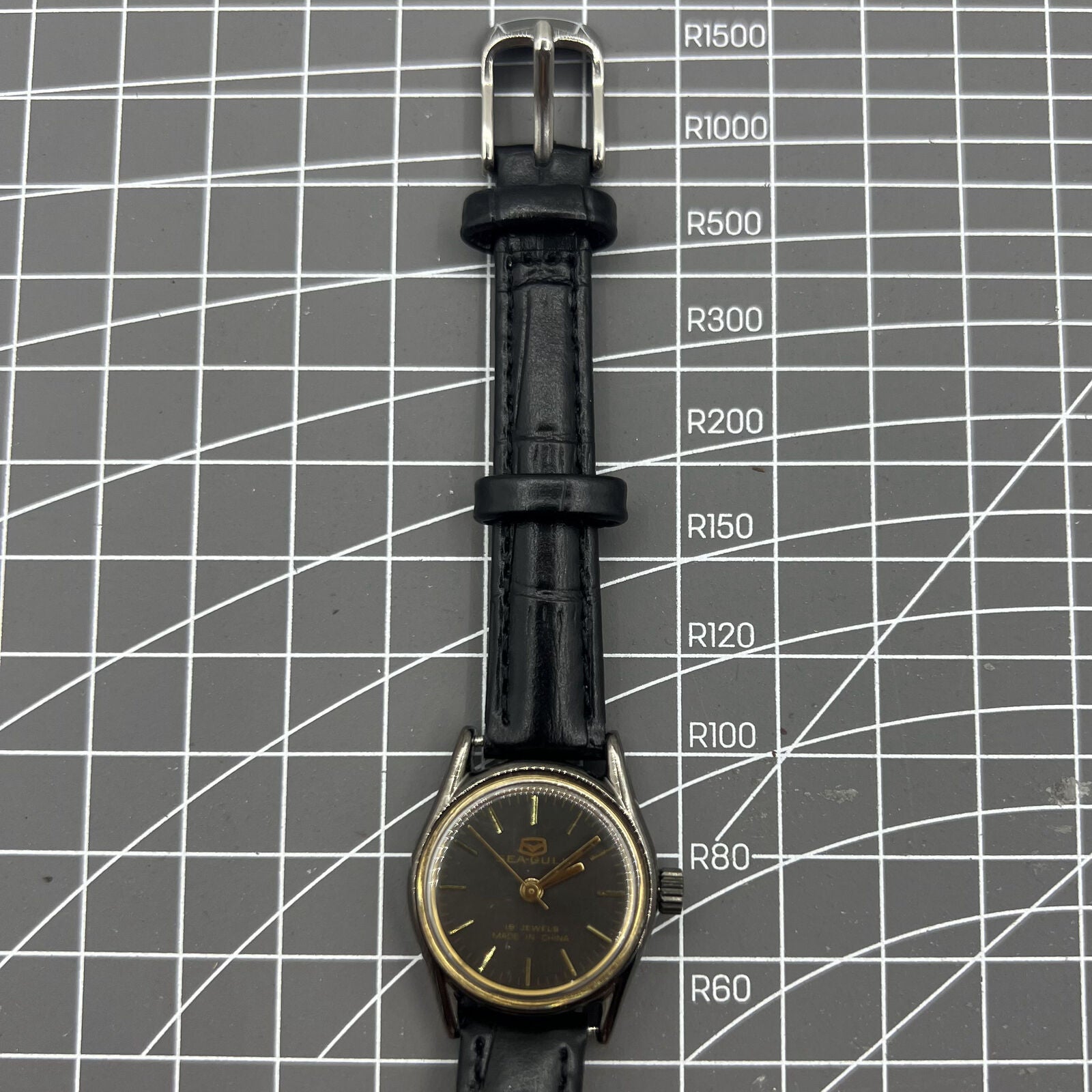 Seagull black case ladies watch with golden nail markers, manual mechanical movement, and shock-resistant build.
