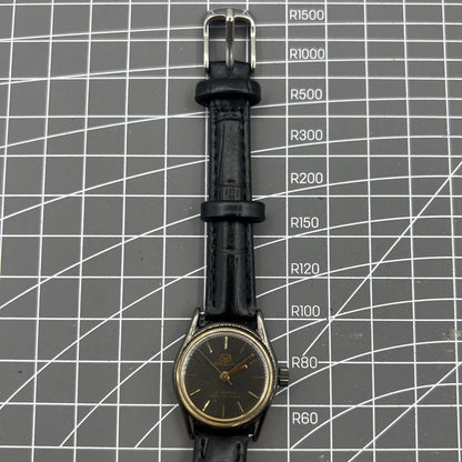 Seagull black case ladies watch with golden nail markers, manual mechanical movement, and shock-resistant build.