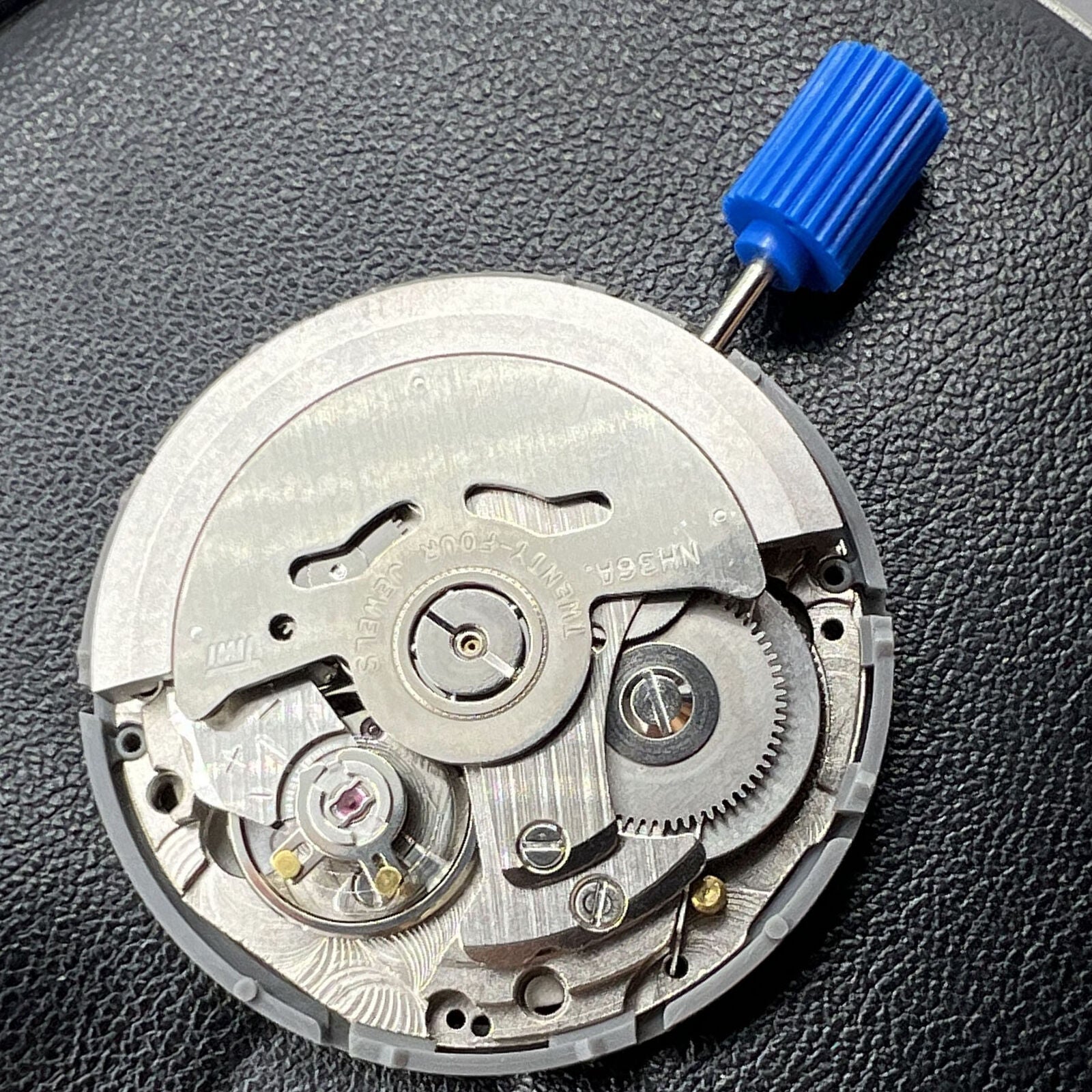 Miyota NH36A watch movement with black finish, green lume, and 3 crown positions for accurate time adjustment.
