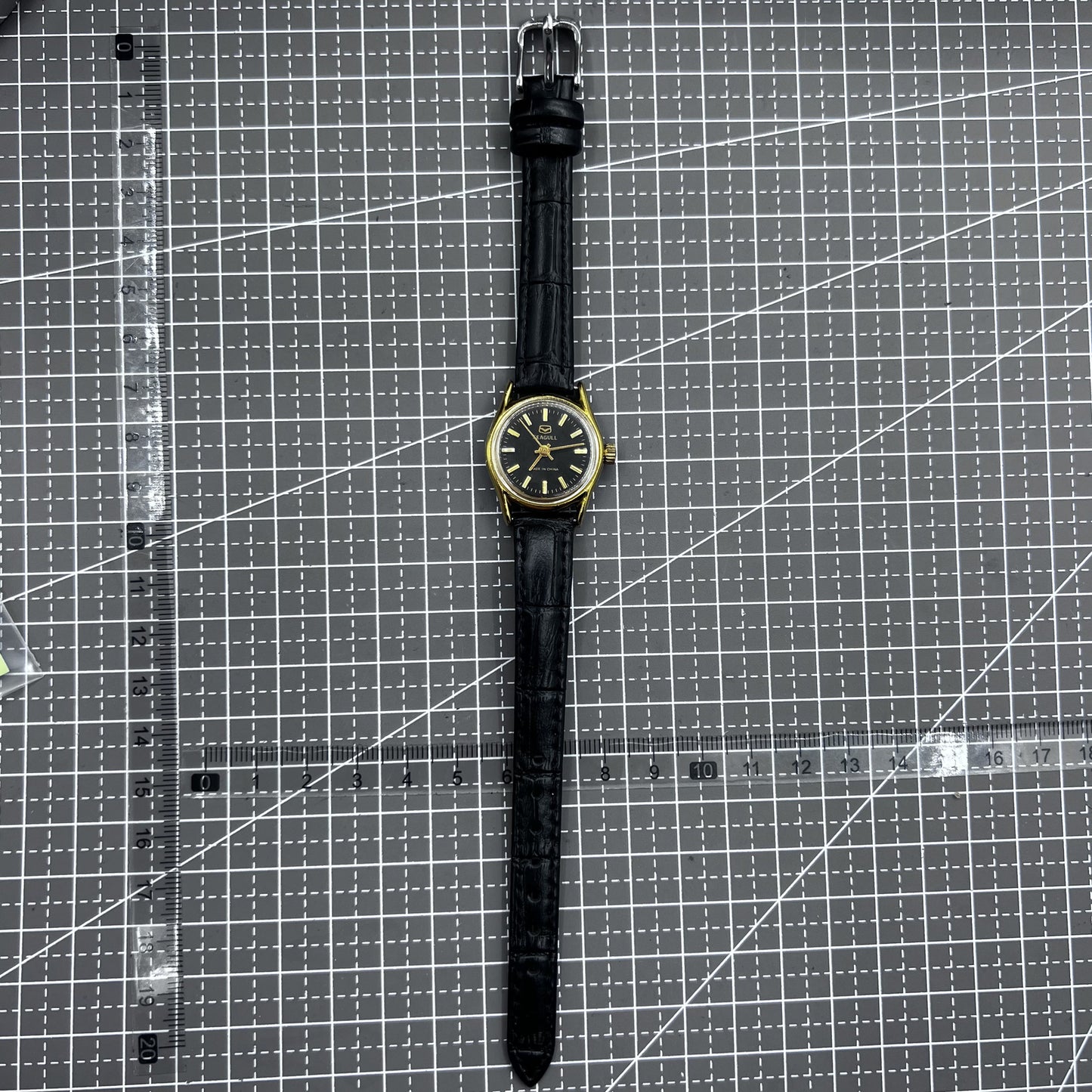 Black round case ladies watch with golden nails, Tianjin Seagull manual mechanical movement, elegant design.