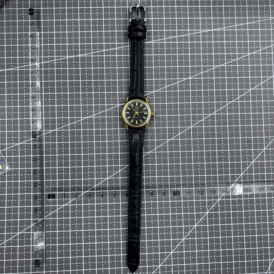 Black round case ladies watch with golden nails, Tianjin Seagull manual mechanical movement, elegant design.