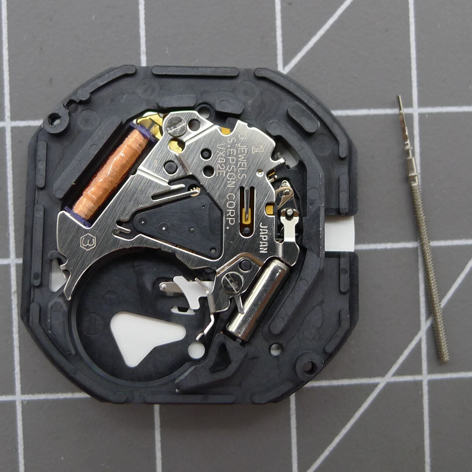 Hattori VX42E quartz watch movement with day display at 3 o'clock, precision Japanese timekeeping component.