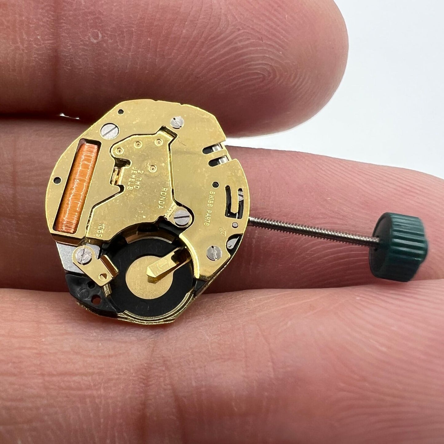 Ronda 1069 golden plated quartz watch movement by Ronda, Swiss-made precision timekeeping component for watch accessories.