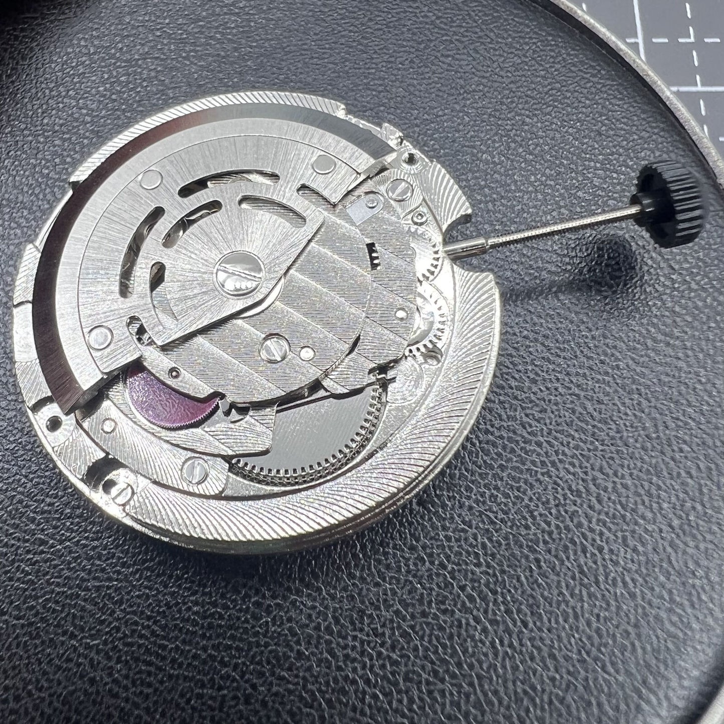 ST2147 automatic mechanical watch with day display at 12 and date window at 3, sleek design.