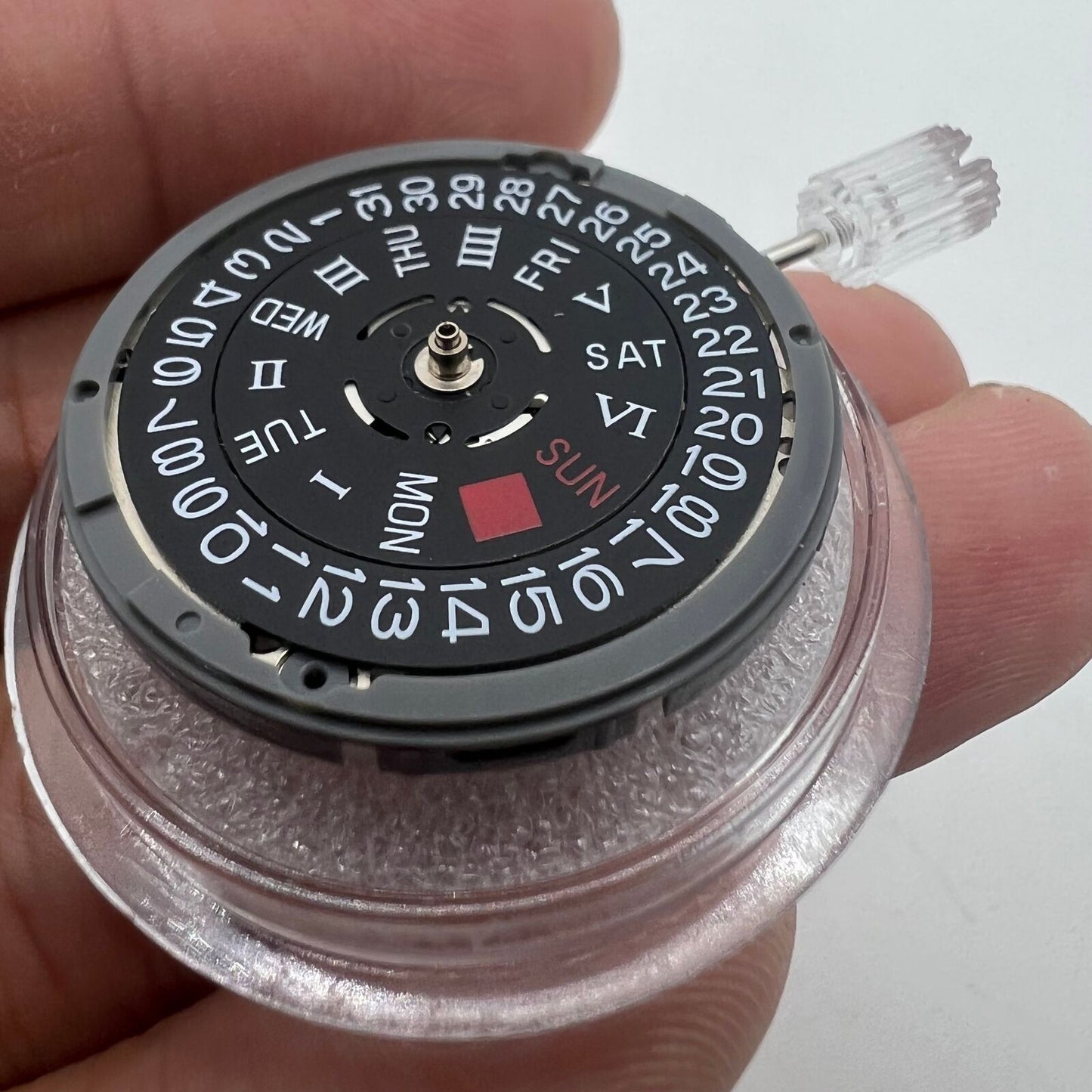 Black NH36A automatic watch movement with Roman wheel and crown positioned at 3 o'clock.