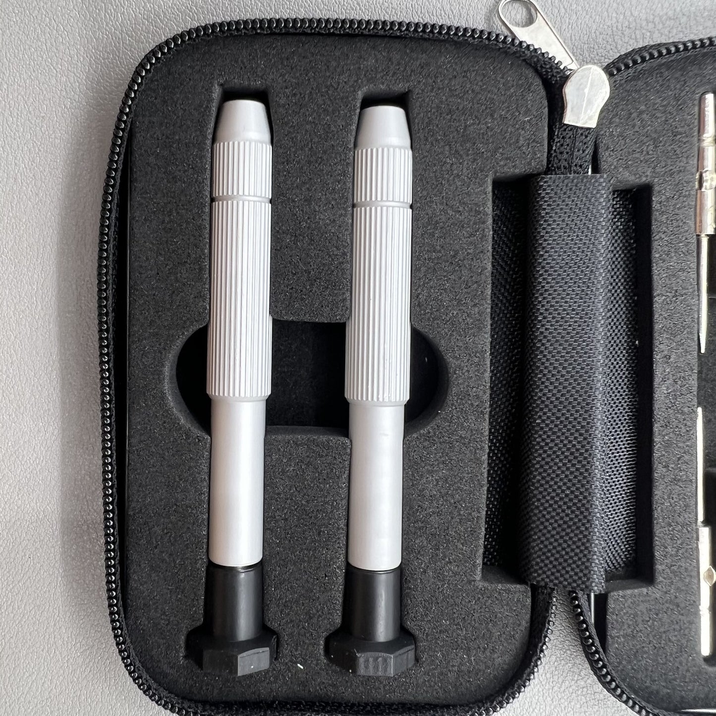 Precision screwdriver set for watch and eyeglass repair, includes hex tools and cutter heads with grip handle.