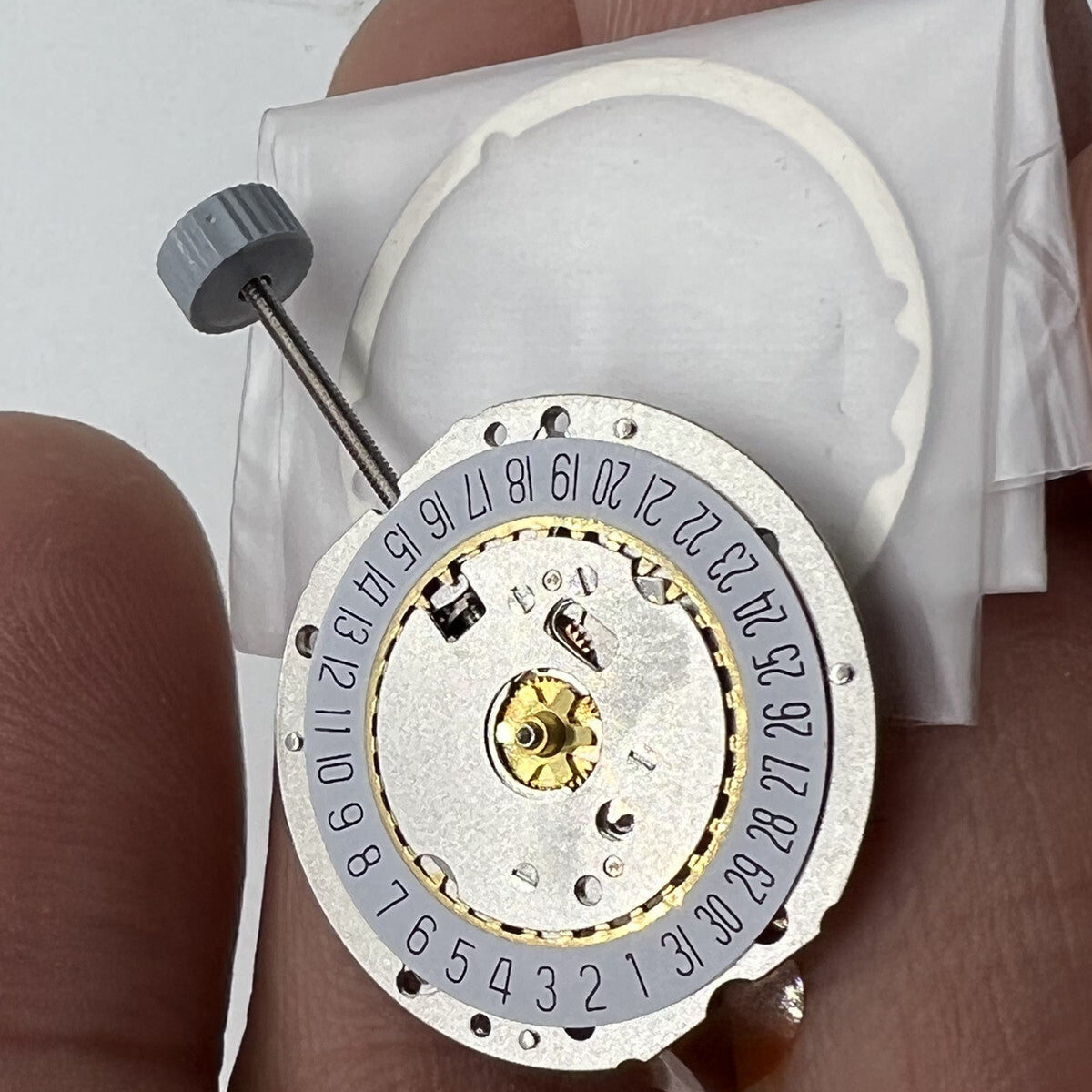 Golden silver-gilted Swiss RONDA 785 calendar quartz movement for precise watch accessory repair.