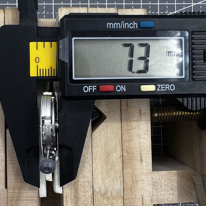 Miyota/Citizen 8215 automatic watch movement with white dial and date window at 6 o'clock for watch repair.