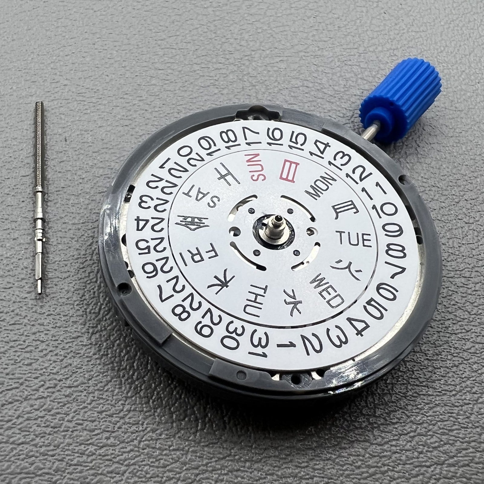 Seiki NH36 watch movement with white dial, featuring Japanese-English day display for precision timekeeping.