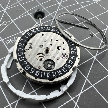 Miyota Citizen 8215 automatic watch movement with black dial, date at 6 o'clock, Japan-made precision.