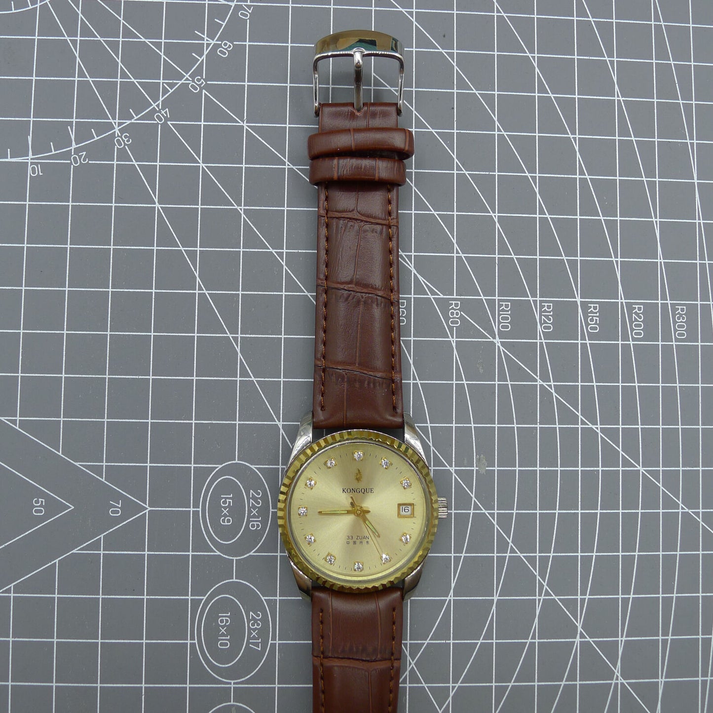 Dandong Peacock 37mm manual watch with golden dial, single calendar, 33 jewels, sleek elegant design accessory.