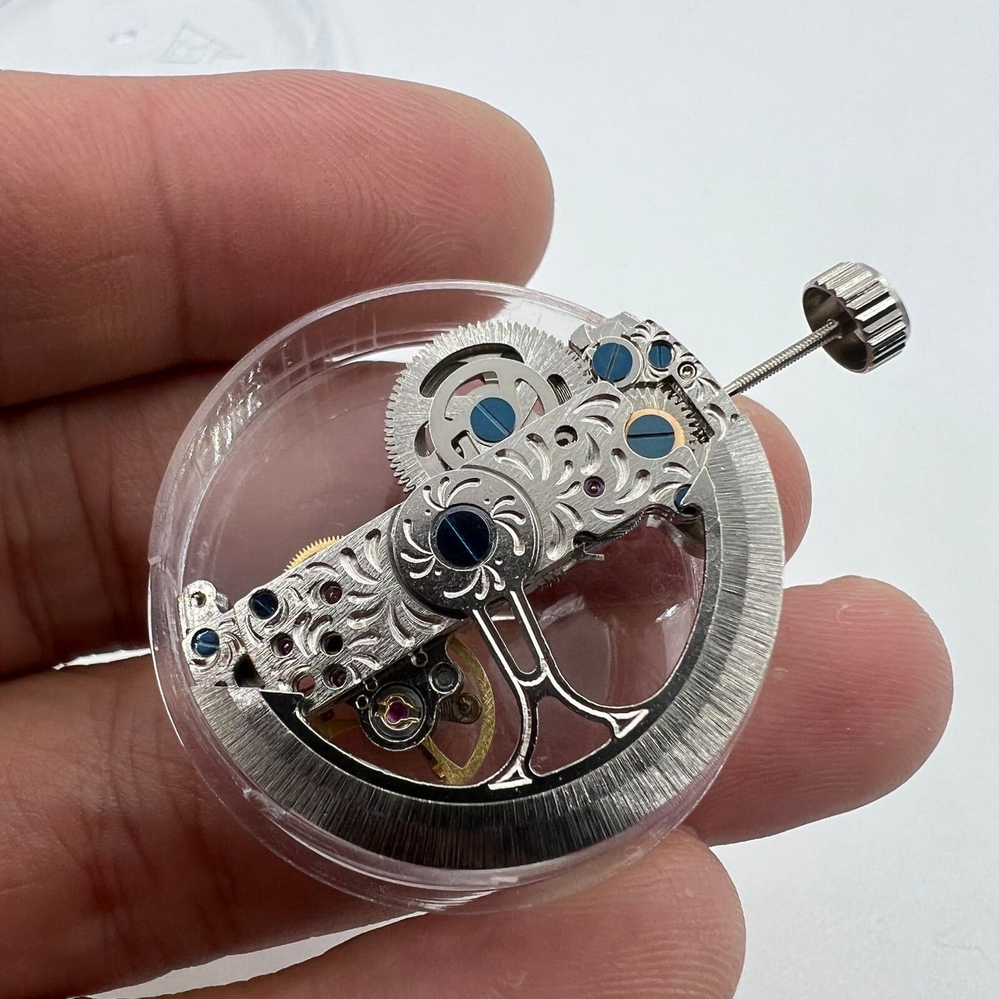 Silver long pendulum wheel watch accessory by Asian, showcasing automatic mechanical movement details