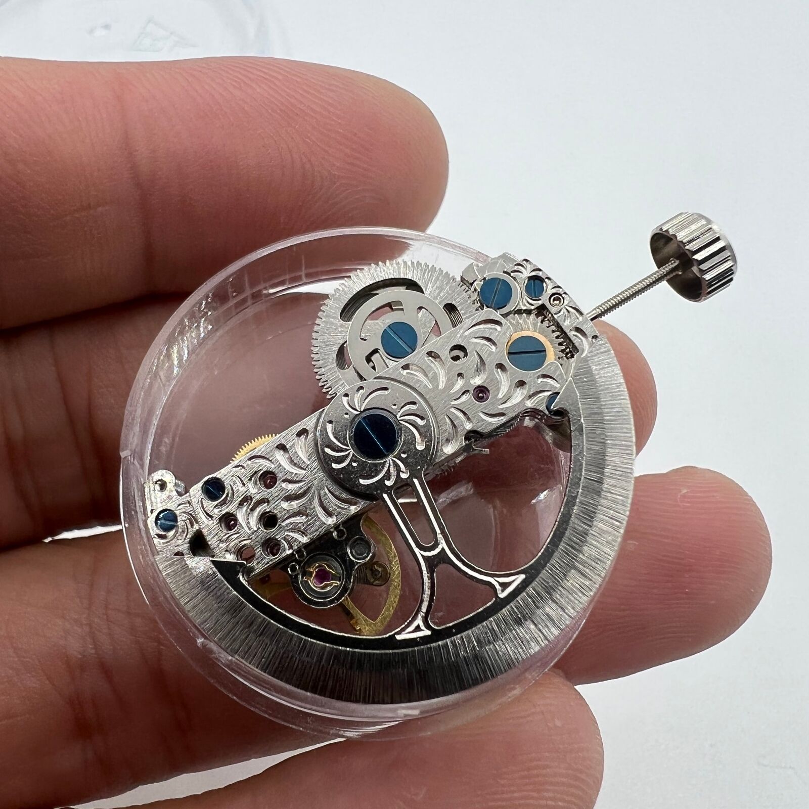 Silver long pendulum wheel watch accessory by Asian, showcasing automatic mechanical movement details