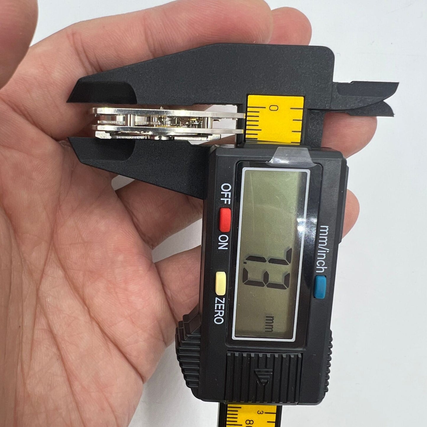 Asian HZ1C01A silver barrel-shaped watch accessory with automatic mechanical movement detail.