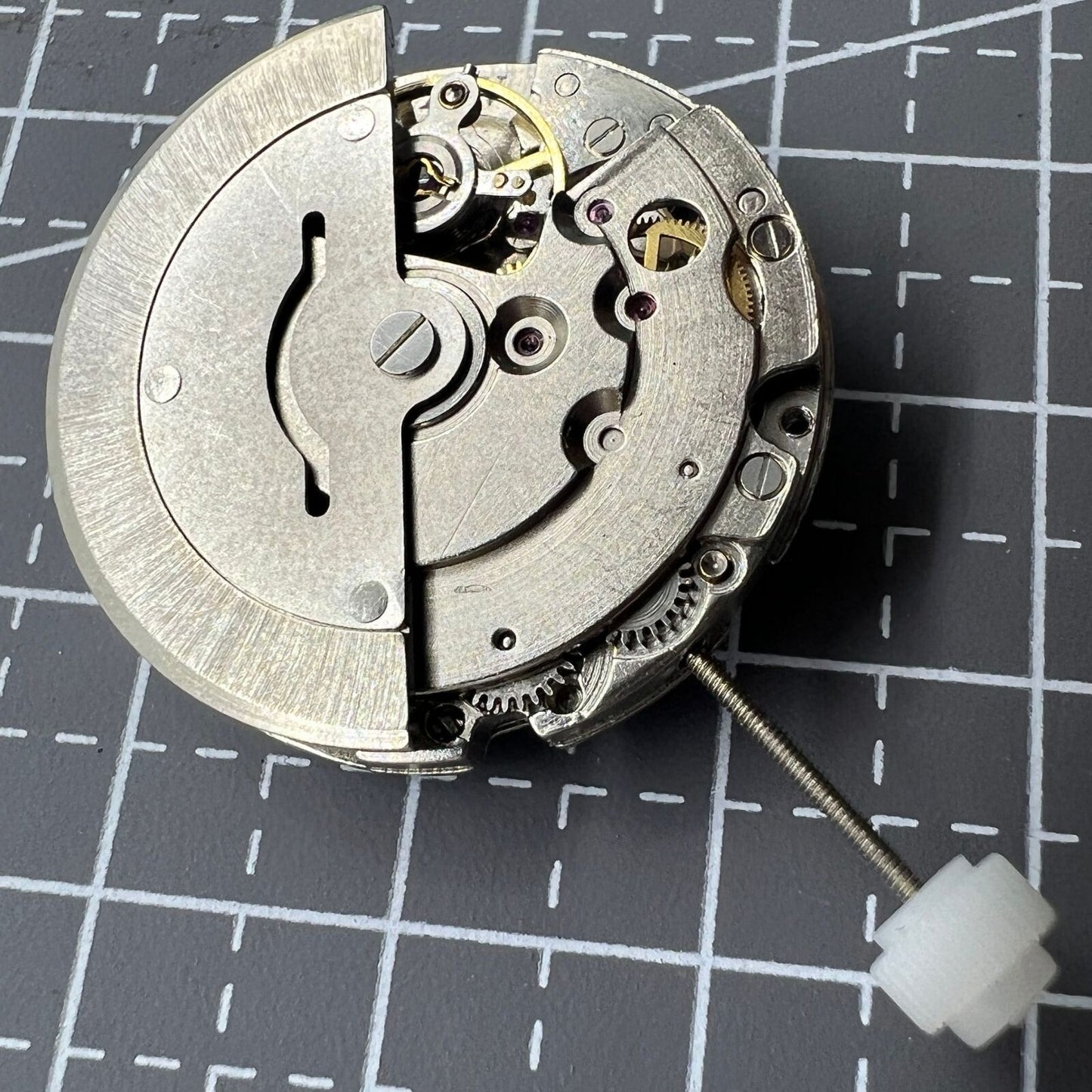 Close-up of China Made 2813 mechanical watch movement displaying single calendar date at 3 o'clock position.