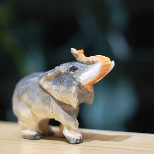 Handcrafted rolled-nosed elephant wooden figurine, perfect for charming home d�cor.