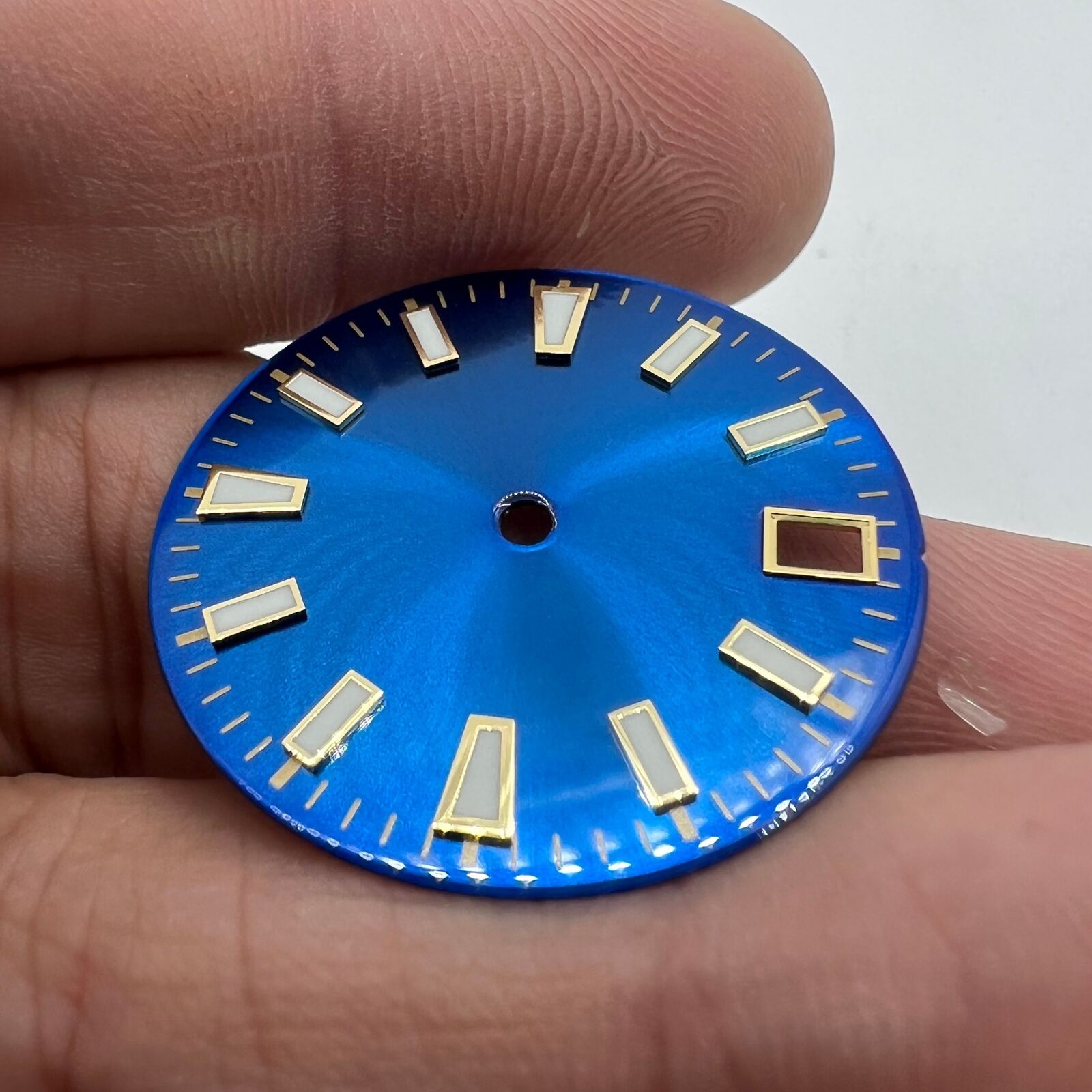 Green luminous blue and gold watch dial for NH35 movement with nail trim detail.