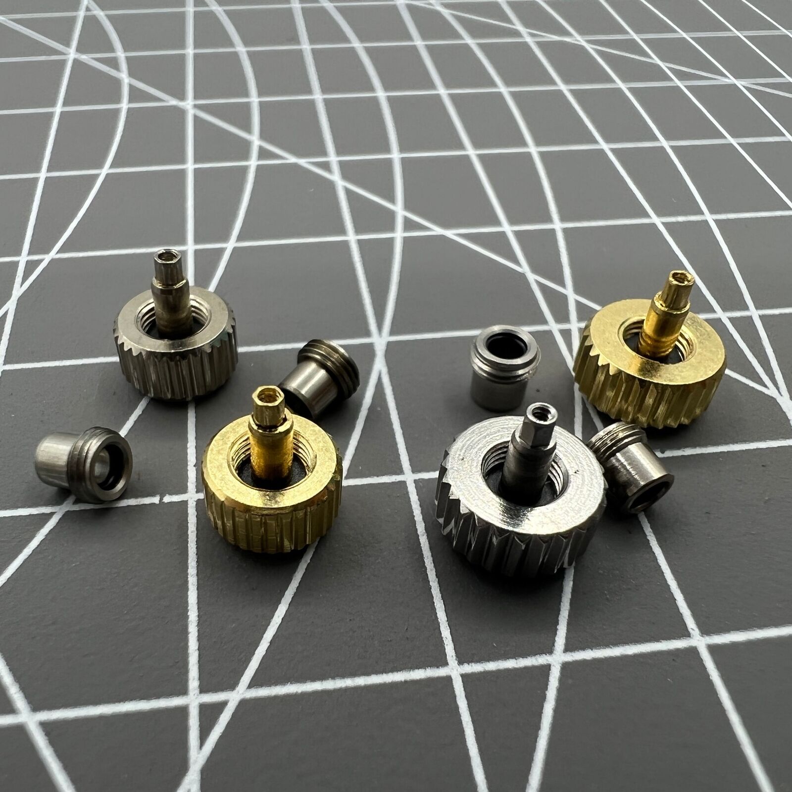 Silver and gold stainless steel screw-on watch crown with gasket for durable replacement - perfect precision part.