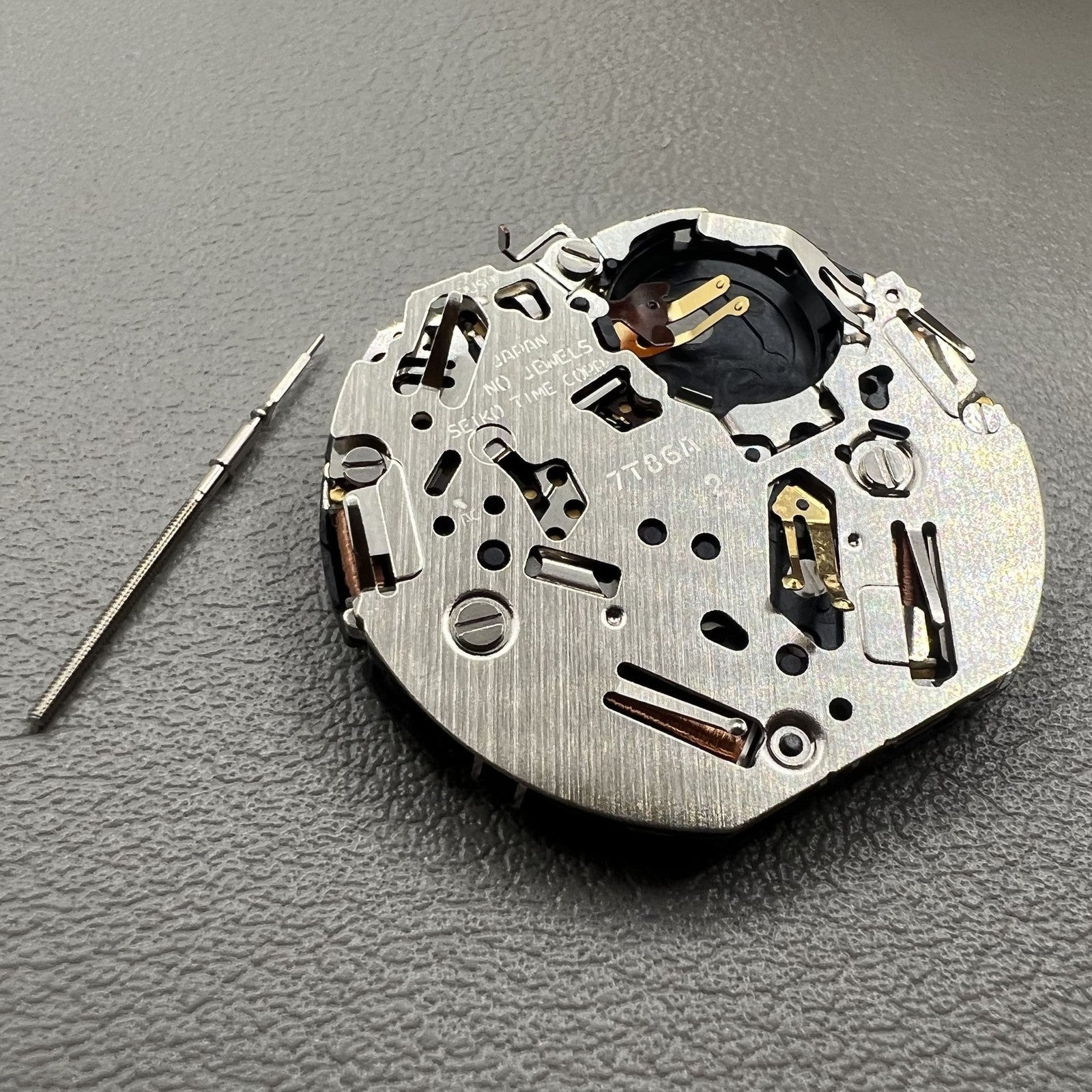 Seiko 7T86A quartz watch movement replacement part, precision Japanese craftsmanship for repairs.