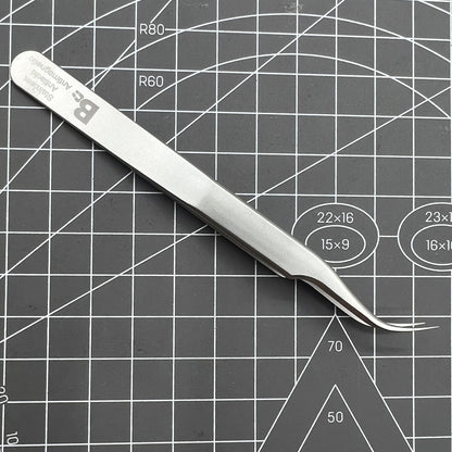 Swiss Bergeon 7026-7 antimagnetic curved tweezer for precise handling of delicate watch accessories.