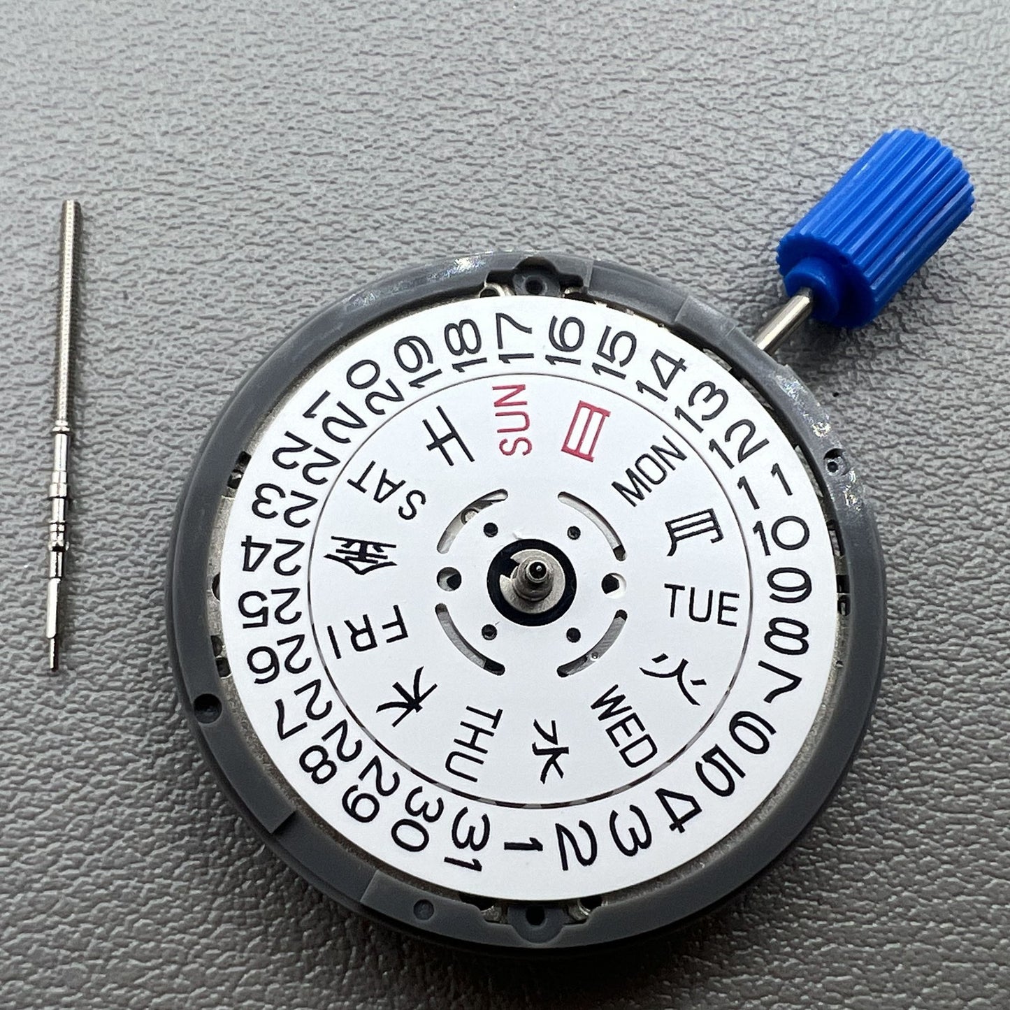 Seiki NH36 watch movement with white dial, featuring Japanese-English day display for precision timekeeping.