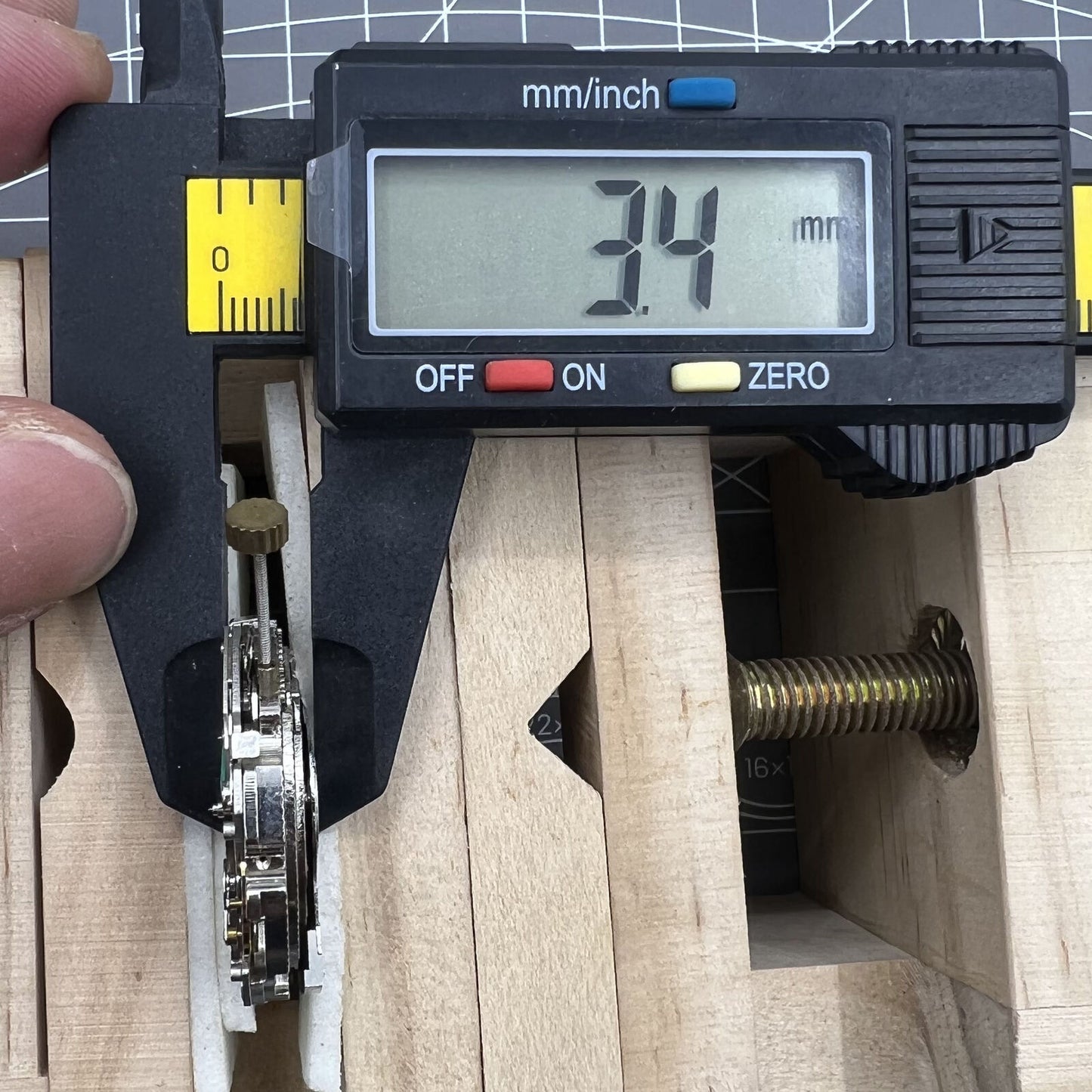 Automatic mechanical watch with reversed balance wheel and large date display at 12 o'clock.