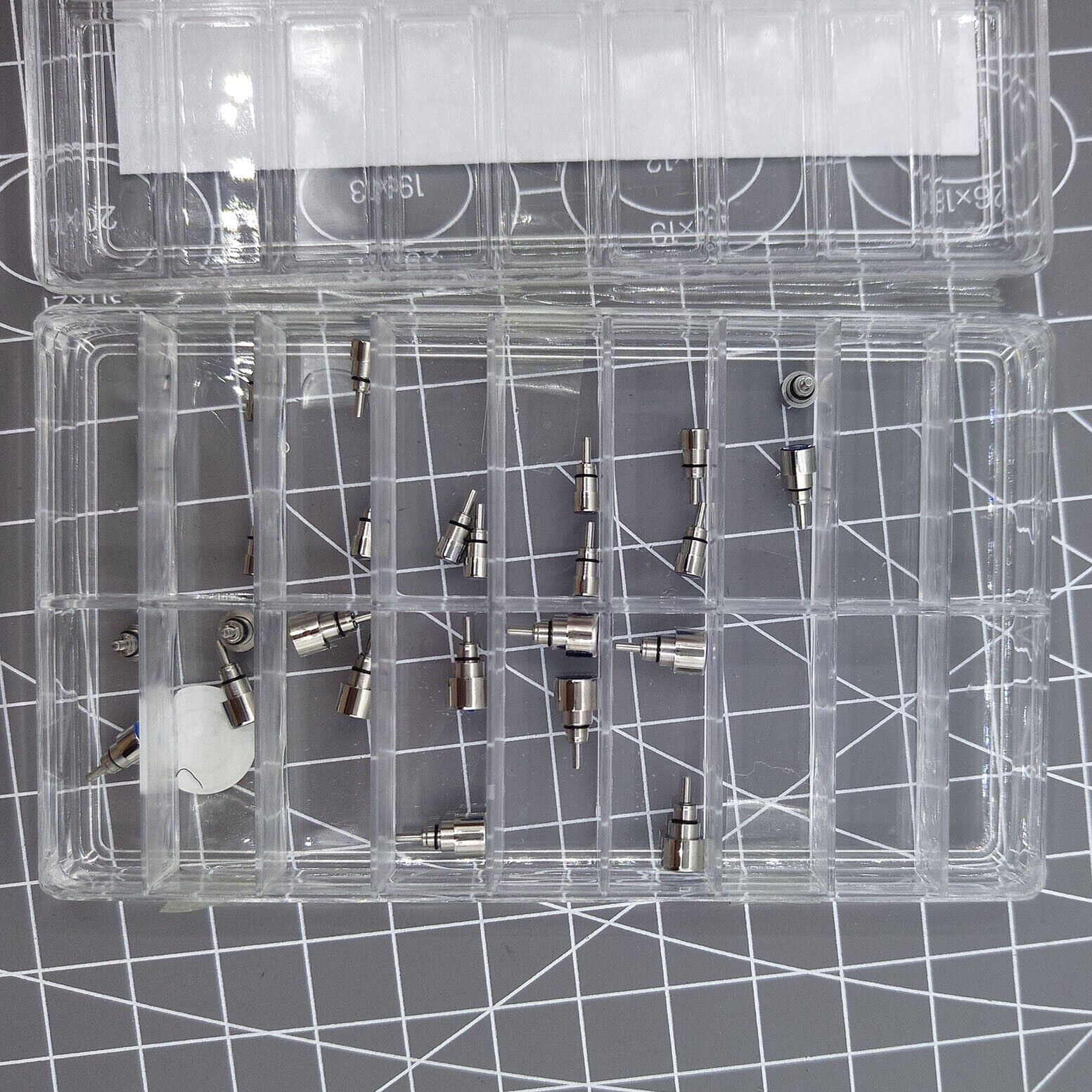 Set of 26 stainless steel chronograph and screw-in watch pushers for precise watch repairs.