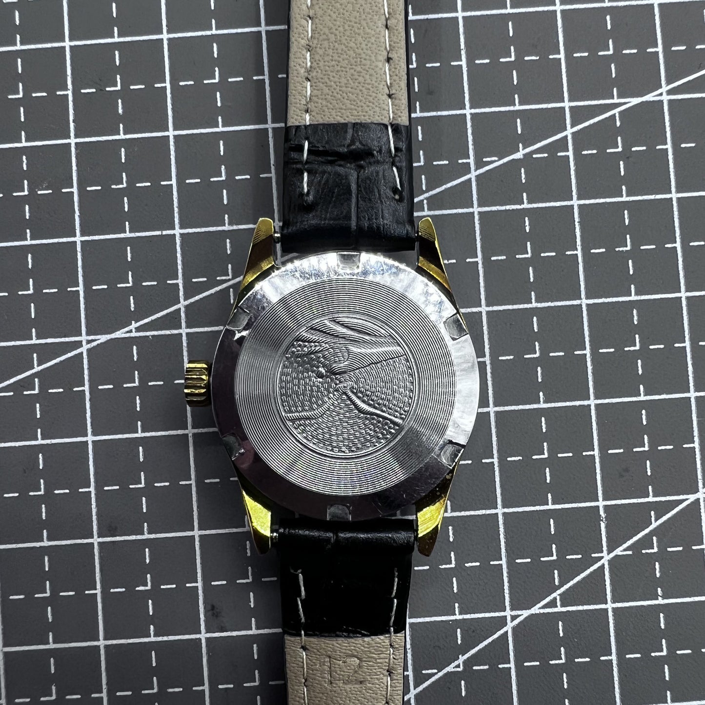 Black round case ladies watch with golden markers, Tianjin Seagull manual movement, elegant accessory for formal wear.