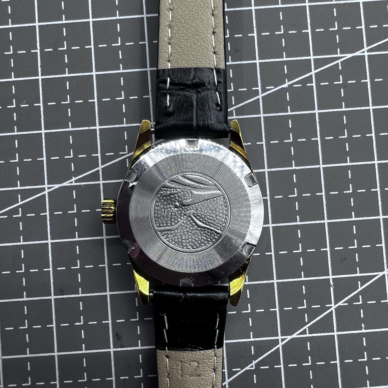 Black round case ladies watch with golden markers, Tianjin Seagull manual movement, elegant accessory for formal wear.