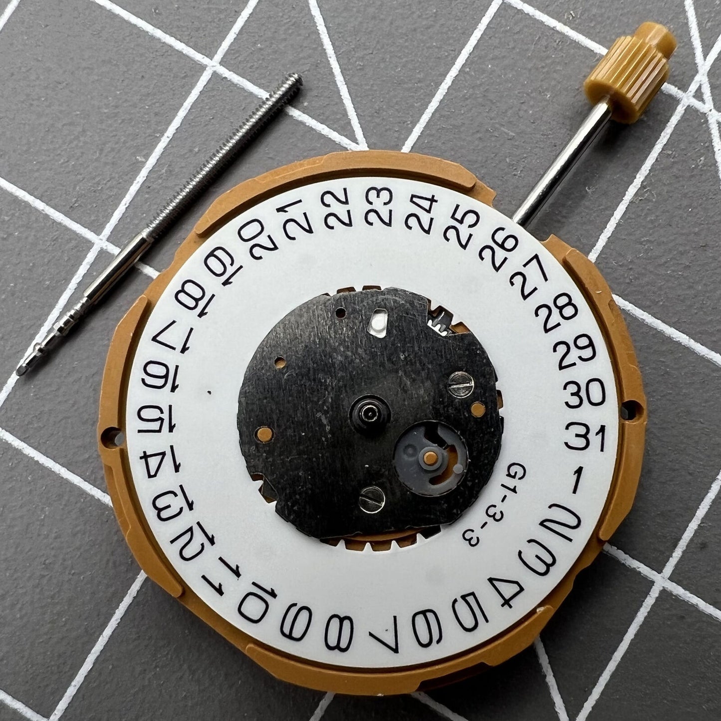 Miyota GM10 quartz watch movement showing date display at 3 o'clock, Japan-made precision mechanism for accurate timekeeping