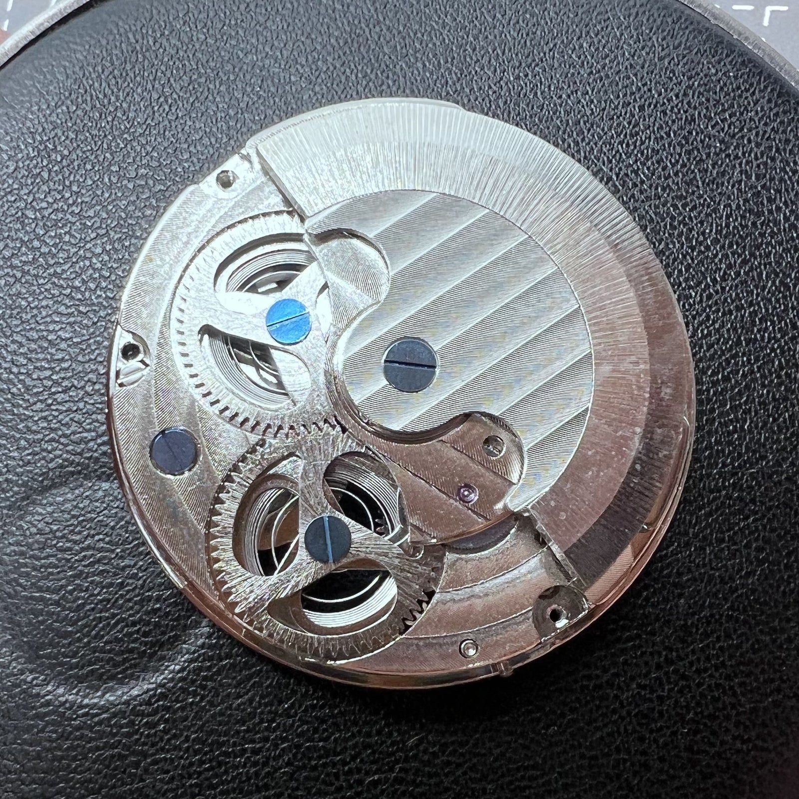 Small silver hollow watch movement with double mainspring and balance wheel at 6 o?clock by Kleines brand.