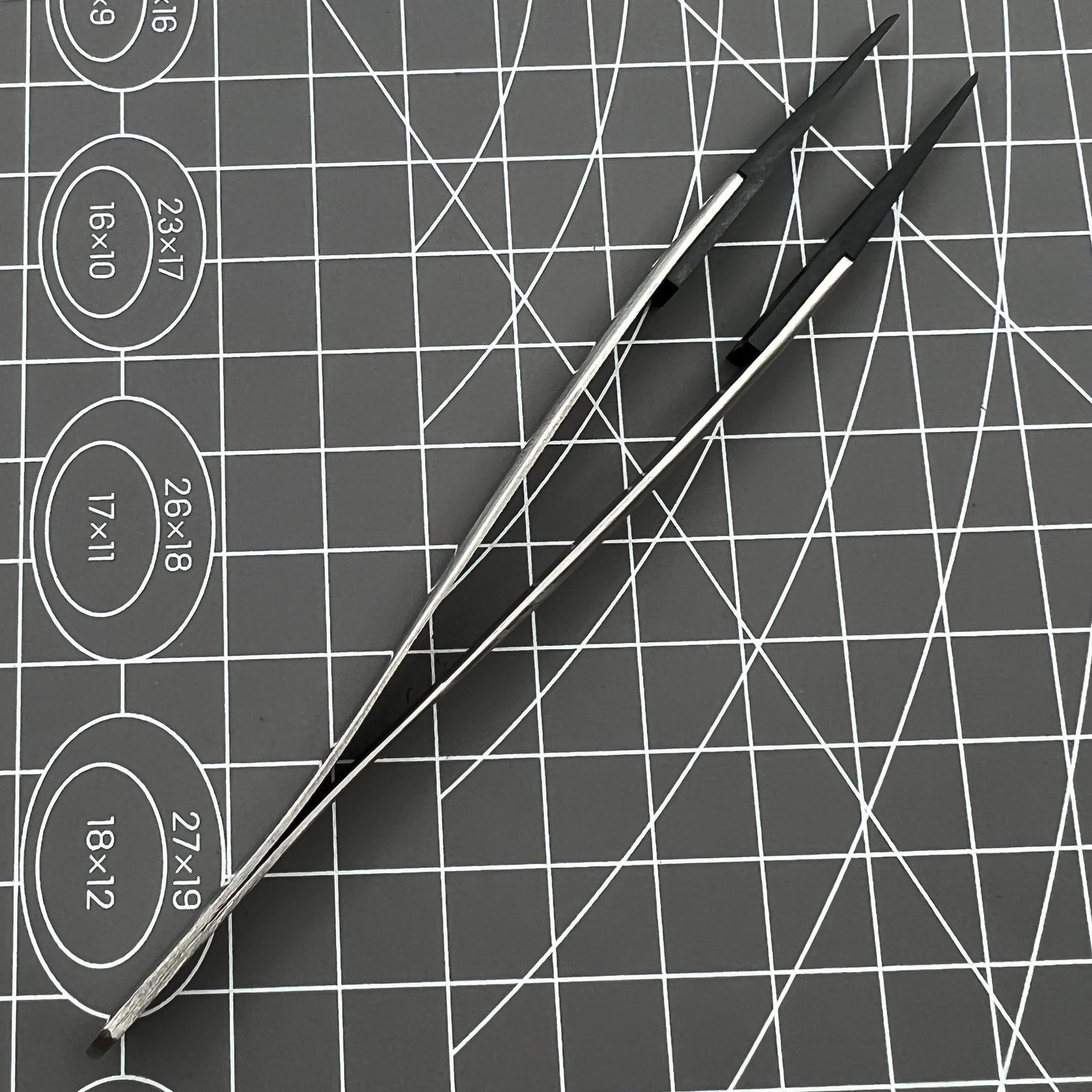 Stainless steel Carbon Fiber Head Tweezers for precise watch repair tasks.