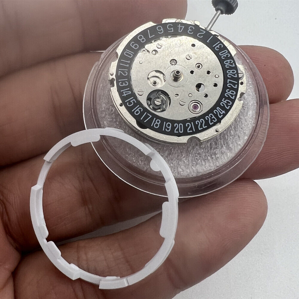 Miyota/Citizen 8215 watch movement with black dial, date at 6, Japan automatic mechanical design.