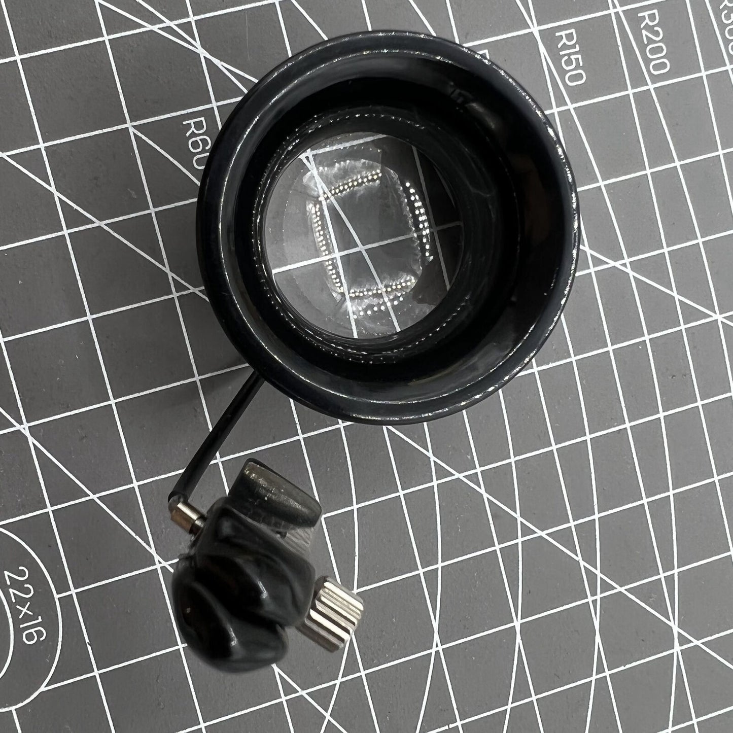 Swiss Bergeon eyeglass with clip for glasses, precision magnifier aiding detailed watch repairs.