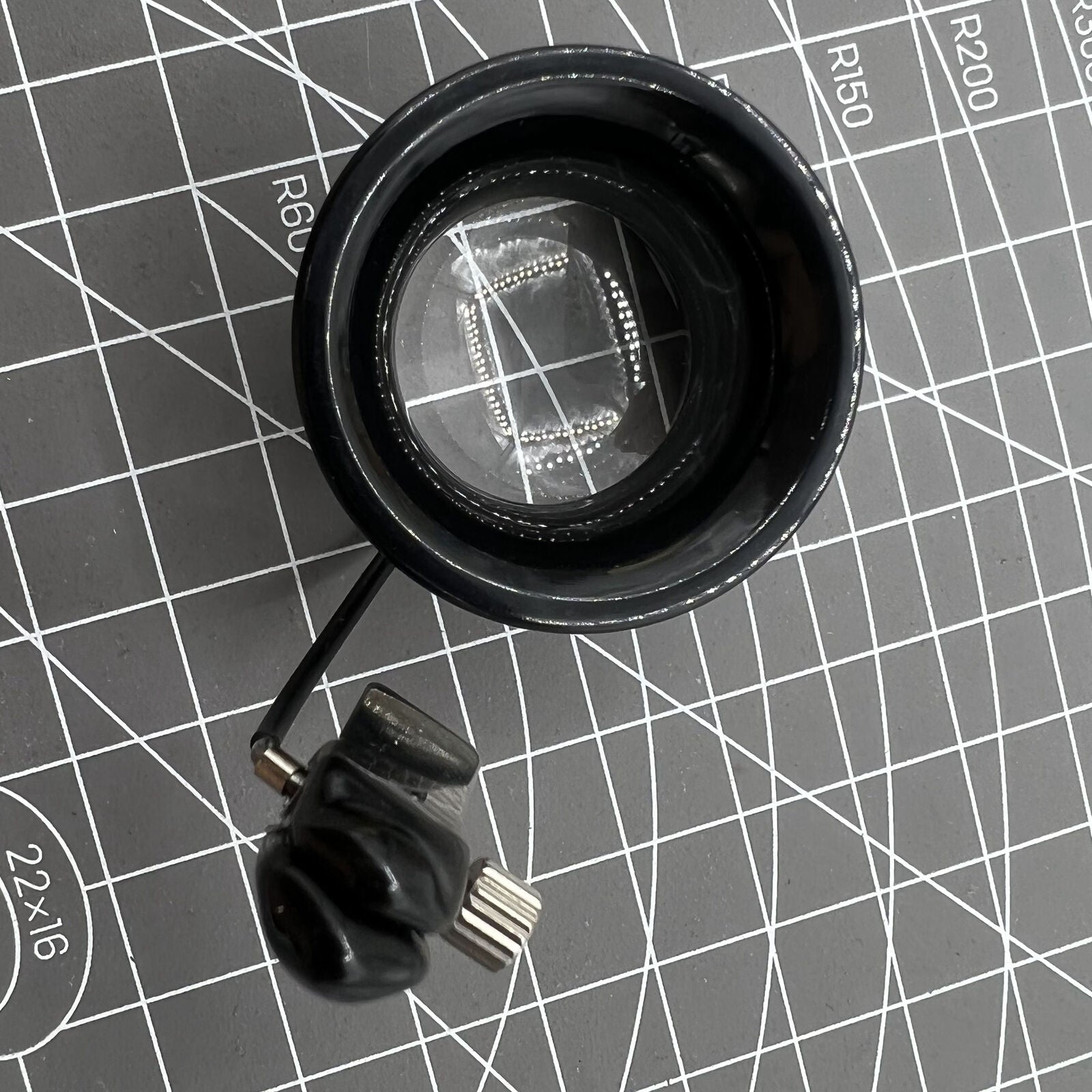 Swiss Bergeon eyeglass with clip for glasses, precision magnifier aiding detailed watch repairs.