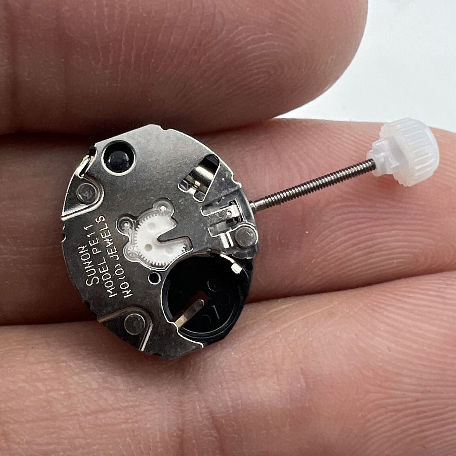 Sunon PE11 quartz watch repair parts displaying hour, minute, and second hands for accurate timekeeping.