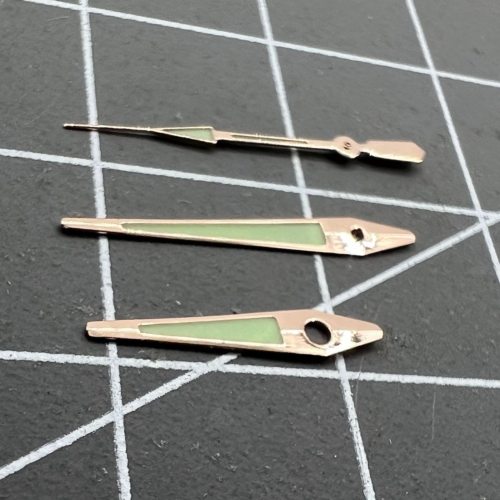 Rose Golden 14mm arrow-shaped luminous watch hands by ISA, enhancing green visibility and precise time reading.