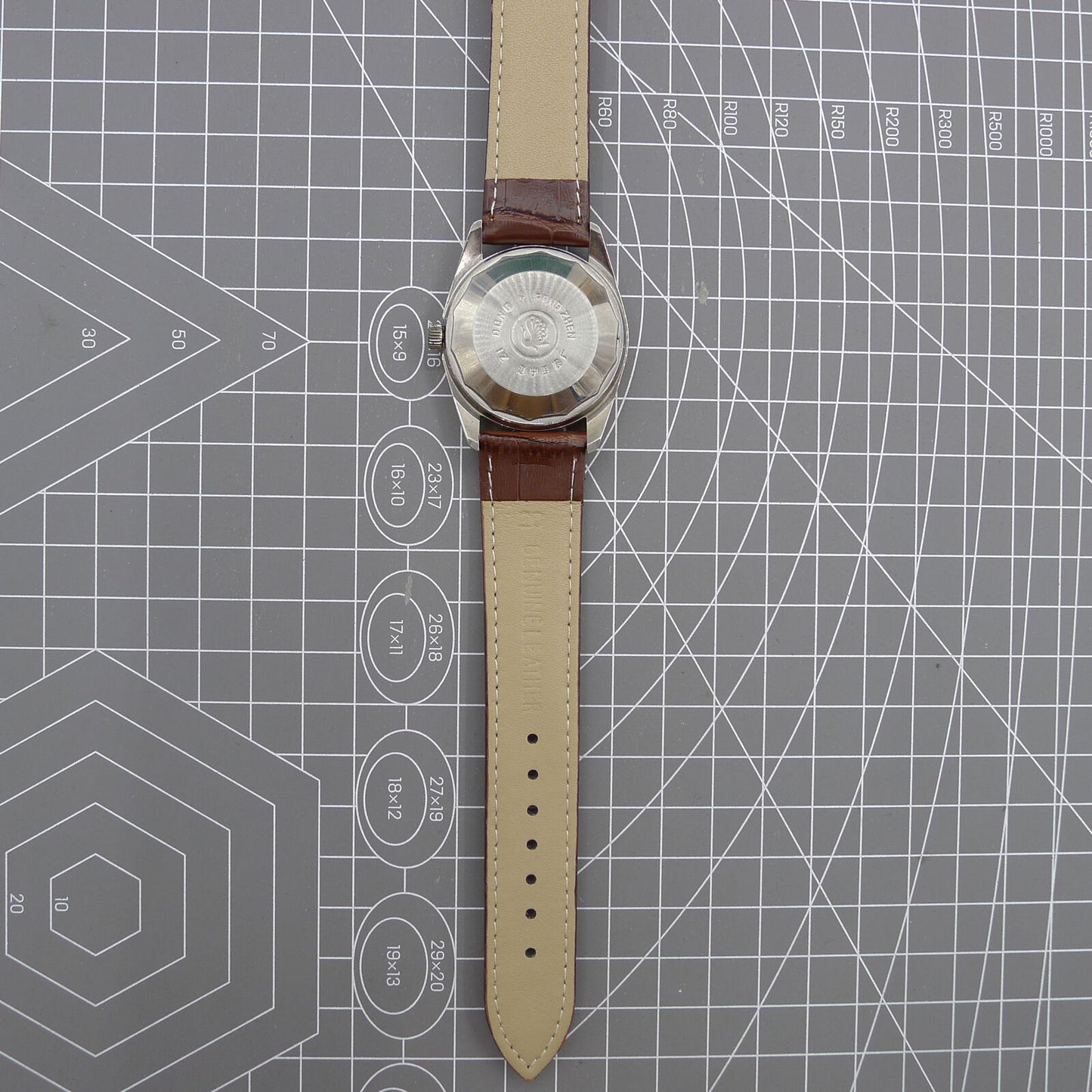 Dandong Peacock 37mm manual watch with golden dial, single calendar, 33 jewels, elegant style for formal wear.