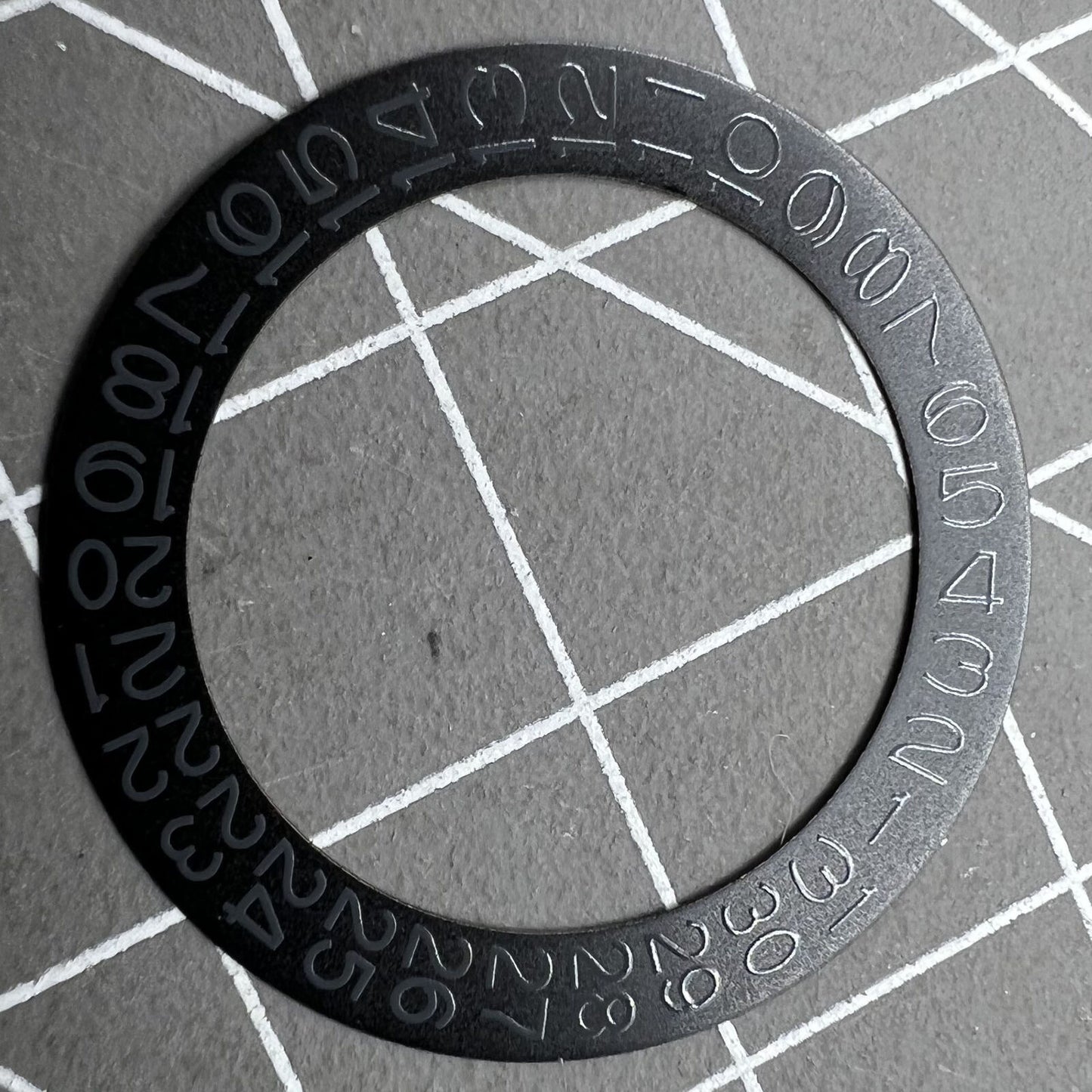 Grey date wheel for NH35 NH36 watch movement, black background, precise date display component.