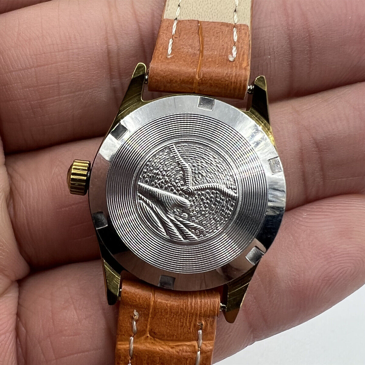 Round golden ladies watch by China Tianjin Seagull, manual mechanical movement with elegant nail markers.