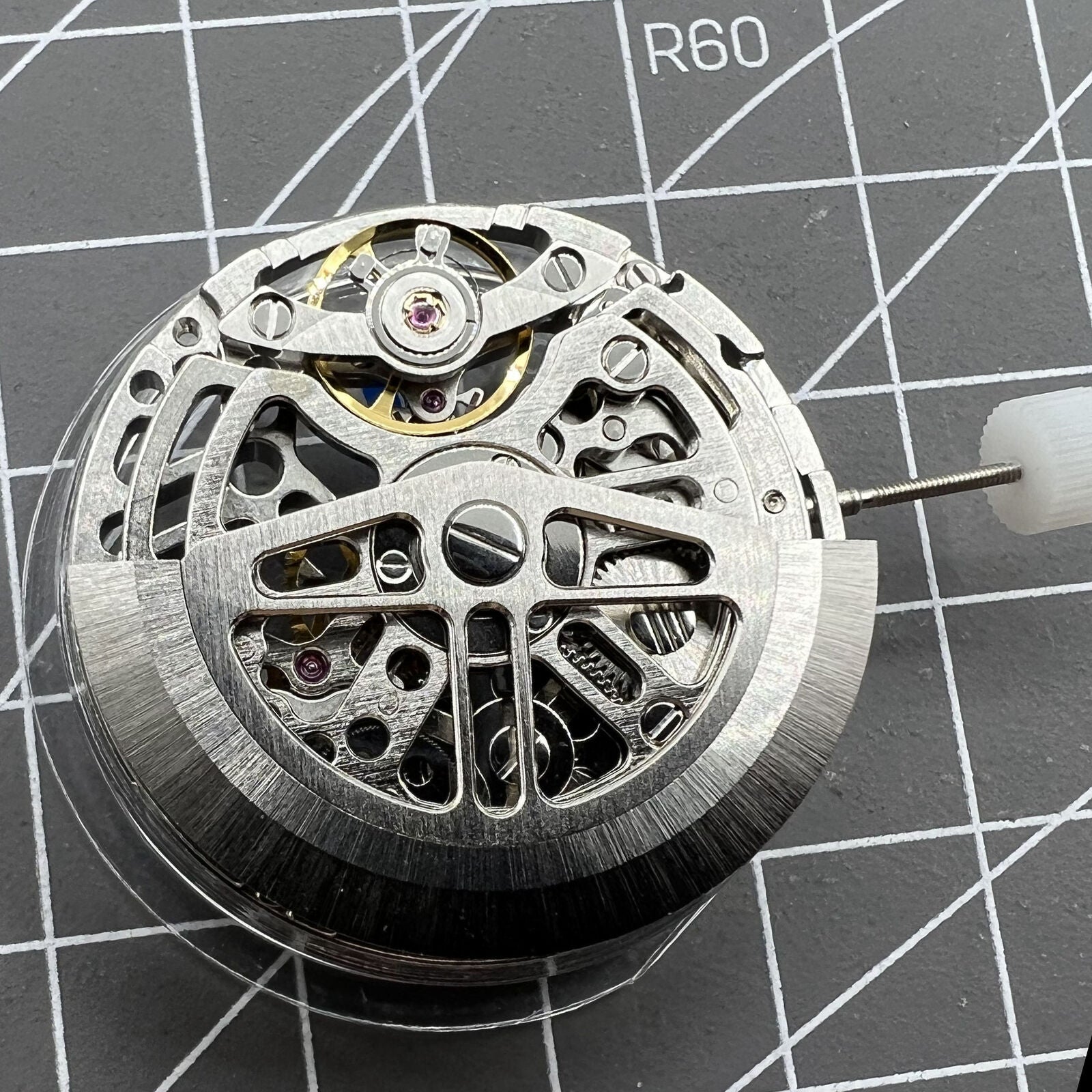 Asian HZ75DOA silver hollow balance wheel displaying automatic mechanical movement detail for watch enthusiasts.